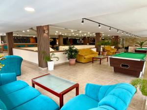 a lobby with blue couches and a pool table at BSA Gradina Hotel - All Inclusive & Private Beach in Golden Sands