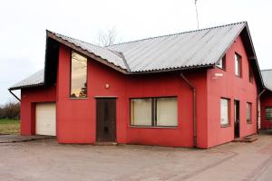 a red house with a metal roof at Motelis Astarte in Koknese