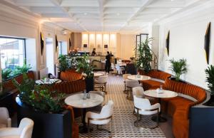 a restaurant with tables and chairs and people in the background at The berg's 2 in Ocna-Mureşului