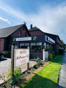 a hotel with a sign in front of a building at Hotel Holtriemer Hof in Nenndorf