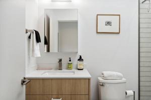 a bathroom with a sink and a mirror and a toilet at Unique Design 2-bedroom Apartment - 80 Walkscore! in Phoenix +12 photos