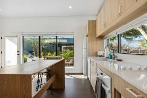 a kitchen with wooden cabinets and a large window at Unique Design 2-bedroom Apartment - 80 Walkscore! in Phoenix