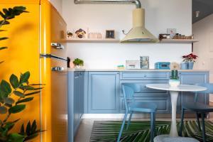 a kitchen with blue cabinets and a table and chairs at Amici Miei Makarska in Makarska