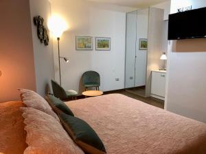 a bedroom with a large bed and a desk at B&B La Valle in Novafeltria