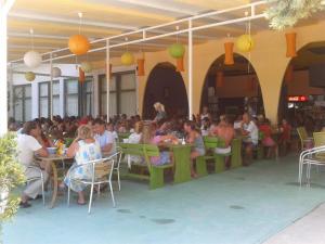 a group of people sitting at tables in a restaurant at Hotel Zora in Kranevo