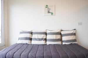 Bett mit Kissen darauf in einem Zimmer in der Unterkunft Ushuaia Sunset Apart in Ushuaia