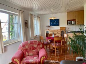 a living room with a couch and a dining room at Dat Spatzenhus 2 in Wangerooge