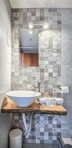 Hostal La Palmera في توريمولينوس: حمام مع حوض أبيض كبير على منضدة