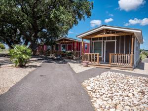 a row of cottages at a resort at D&R Rivercity RV Resort in New Braunfels