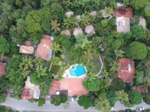 an overhead view of a house with a pool in the forest at Pousada Jacarandá by Rivaj in Trancoso