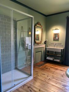 a bathroom with a glass shower and a sink at Moulin de Joumard, chambres et table d'hôtes de charme , jacuzzi, sauna, piscine et bain nordique 