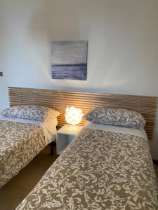 two beds sitting next to each other in a room at WestHouse in Pescara