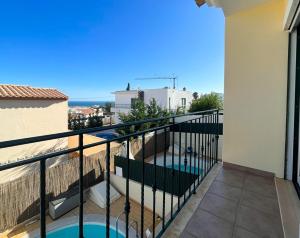 a balcony with a view of the ocean at Moradia T3 Aguia Marina, com piscina e BBQ in Páteo