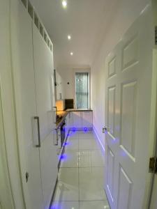 an empty hallway with a door and purple lights at Designer Apartment APT6 in Wolverhampton