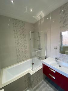 a bathroom with a shower and a tub and a sink at Designer Apartment APT6 in Wolverhampton