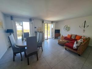 a living room with a table and a couch at Villa K Presqu ile de Giens in Hyères