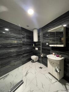 a bathroom with a toilet and a sink and a mirror at Diamond Hotel & Restaurant Ulcinj in Ulcinj +70 photos