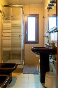 a bathroom with a glass shower and a sink at Residenza San Luca in Muro Lucano