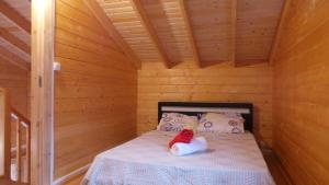 a bedroom with a bed in a wooden cabin at Chalet des Remparts in Sainte-Marie