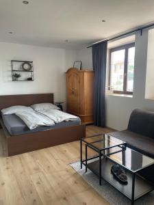 a bedroom with a bed and a couch and a table at Apartment Dubnica Prejta in Dubnica nad Váhom