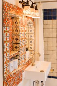 a bathroom with a sink and a tile wall at Pueblo Bonito Inn in Santa Fe +44 photos