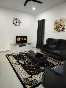 a living room with a couch and a table at Homestay Temerloh Near Hospital with Private Pool Wi-Fi Netflix in Temerloh