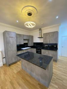 a large kitchen with a large island in the middle at Luxury Apartment APT4 in Wolverhampton