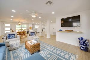 a living room with a blue couch and chairs at Lakefront Granite Shoals Escape with Dock! in Granite Shoals