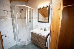 a bathroom with a sink and a shower at Gästehaus Almblick in Schönau am Königssee +42 photos