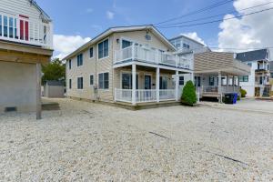 a large house on a gravel driveway in front at Avalon Vacation Rental with Porch and Grill! in Avalon