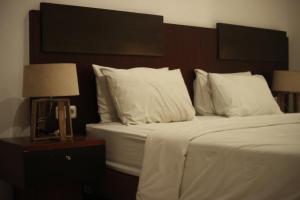 Postel nebo postele na pokoji v ubytování Hotel Graha Kinasih Kotabaru + 13 fotografií