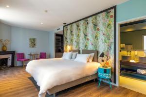 a bedroom with a large bed with a large floral wall at Marmont Hotel in Geneva