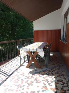 a patio with a table and chairs on a deck at Mátyás király Apartman in Vonyarcvashegy