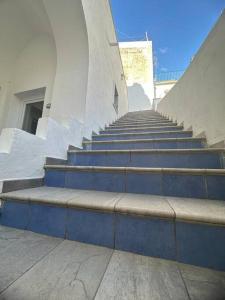 a set of blue stairs in a building at Mana House in Maiori