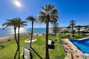 widok na plażę z ośrodka z palmami w obiekcie Santa Clara cozy Sea view Studio w mieście Torremolinos