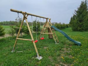 a playground with a slide and a swing at Hiiemäe Puhkemaja in Kunda