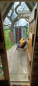 a porch swing with a tree in the background at Down The Rabbit Hole in Waterfall