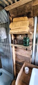 a bathroom with a tub and some towels and a sink at Down The Rabbit Hole in Waterfall