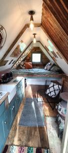 a tiny house with a kitchen and an attic at Down The Rabbit Hole in Waterfall