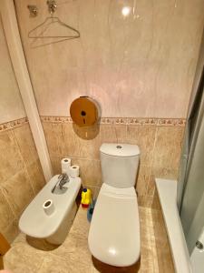 a bathroom with a white toilet and a sink at RoNi RoOms in Salou