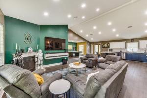 a living room with a couch and a table at Luxe Lake Charles Escape with Home Theater! in Lake Charles