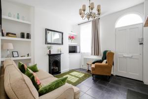 a living room with two couches and a fireplace at Chester Stays - Lovely 2 bedroom house in the heart of Chester in Chester