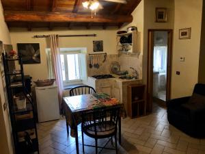 a kitchen with a table and chairs in a room at VITERBO ART APARTMENTS in Viterbo