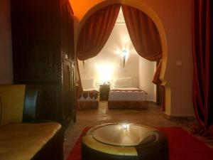 Habitación con 1 dormitorio con 1 cama y 1 mesa. en Riad Rêve d Antan, en Marrakech