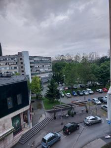 a parking lot with cars parked in a city at Apartman LAURA in Zagreb