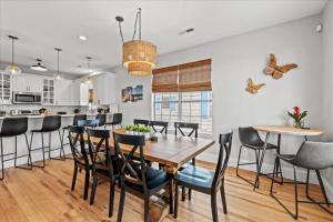 a kitchen and dining room with a wooden table and chairs at Mahalo House in Myrtle Beach