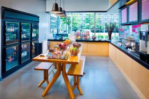 a kitchen with a table with fruits and vegetables on it at Aloft Philadelphia Airport in Philadelphia