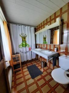 a bathroom with two sinks and a shower curtain at Ferienwohnung Schafbergblick in Wildhaus