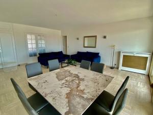 ein Wohnzimmer mit einem großen Tisch und Stühlen in der Unterkunft Central -300m Palais- Seaview-A/C-WIFI-spacieux in Cannes