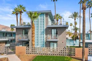 a building with palm trees in front of it at Poolside Studio w Rooftop Deck - Walk to Old Town in Scottsdale